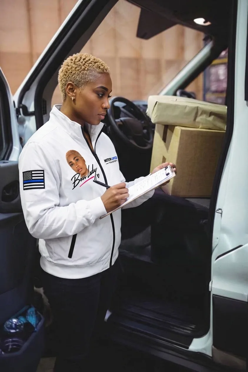 Shanazar reviewing load paperwork at a truck
