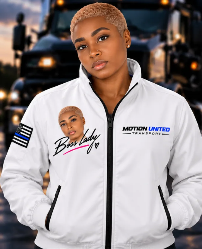 Shanazar, co-founder of Motion United Transport, in a white branded jacket